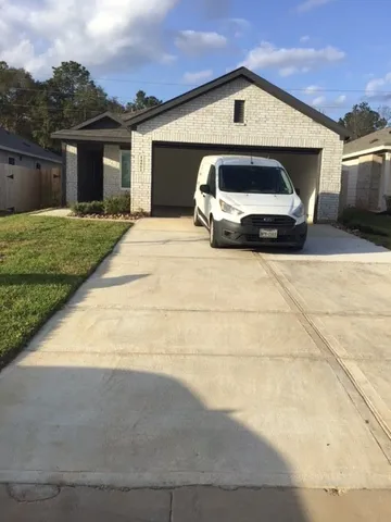 a front view of a house with parking space