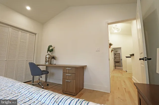 a bedroom with a bed and a chair