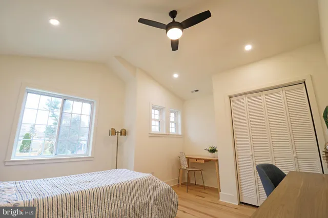 a bedroom with a bed and a potted plant