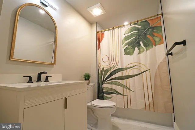 a bedroom with a bed and painting on the wall