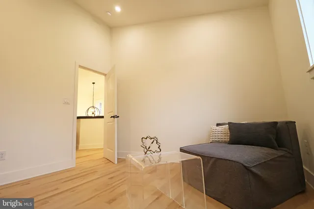 a view of a hallway with a flower pot and a chandelier