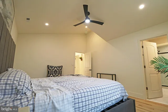 a kitchen with stainless steel appliances kitchen island granite countertop a table chairs and a wooden floor