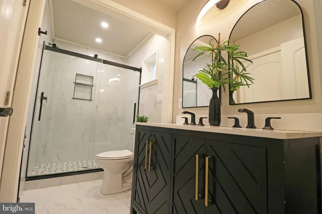 a kitchen with stainless steel appliances granite countertop a refrigerator a stove top oven a sink dishwasher a dining table and chairs with wooden floor