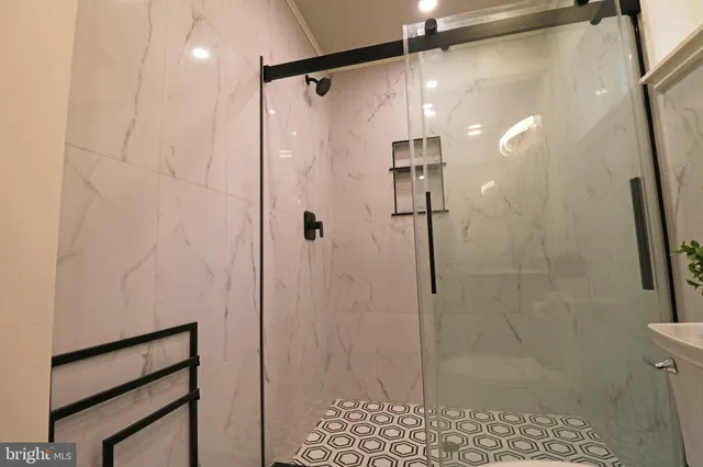 a view of a roof deck with couches and wooden floor