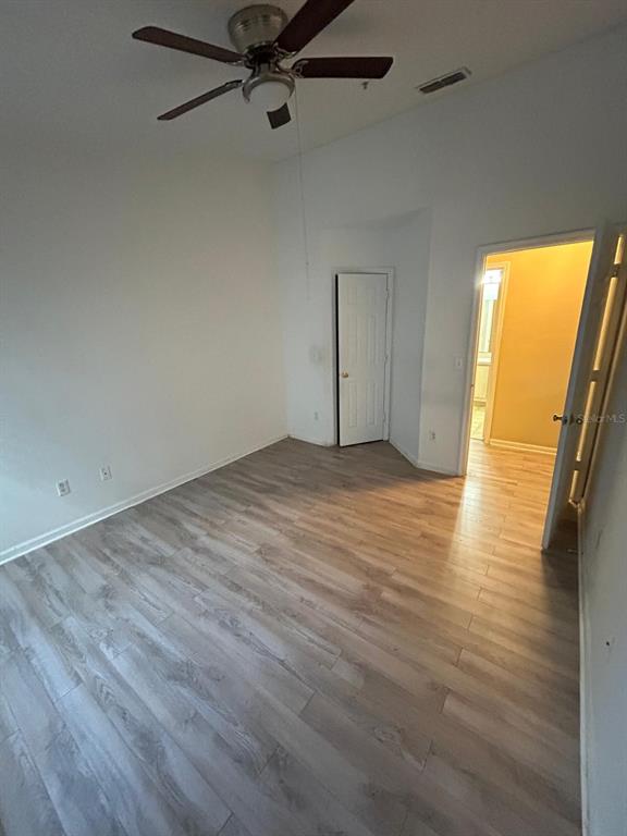 4320 South Kirkman Road, Unit 1 Orlando, FL 32811 - Photo 7 of 10 wooden floor in an empty room with a window