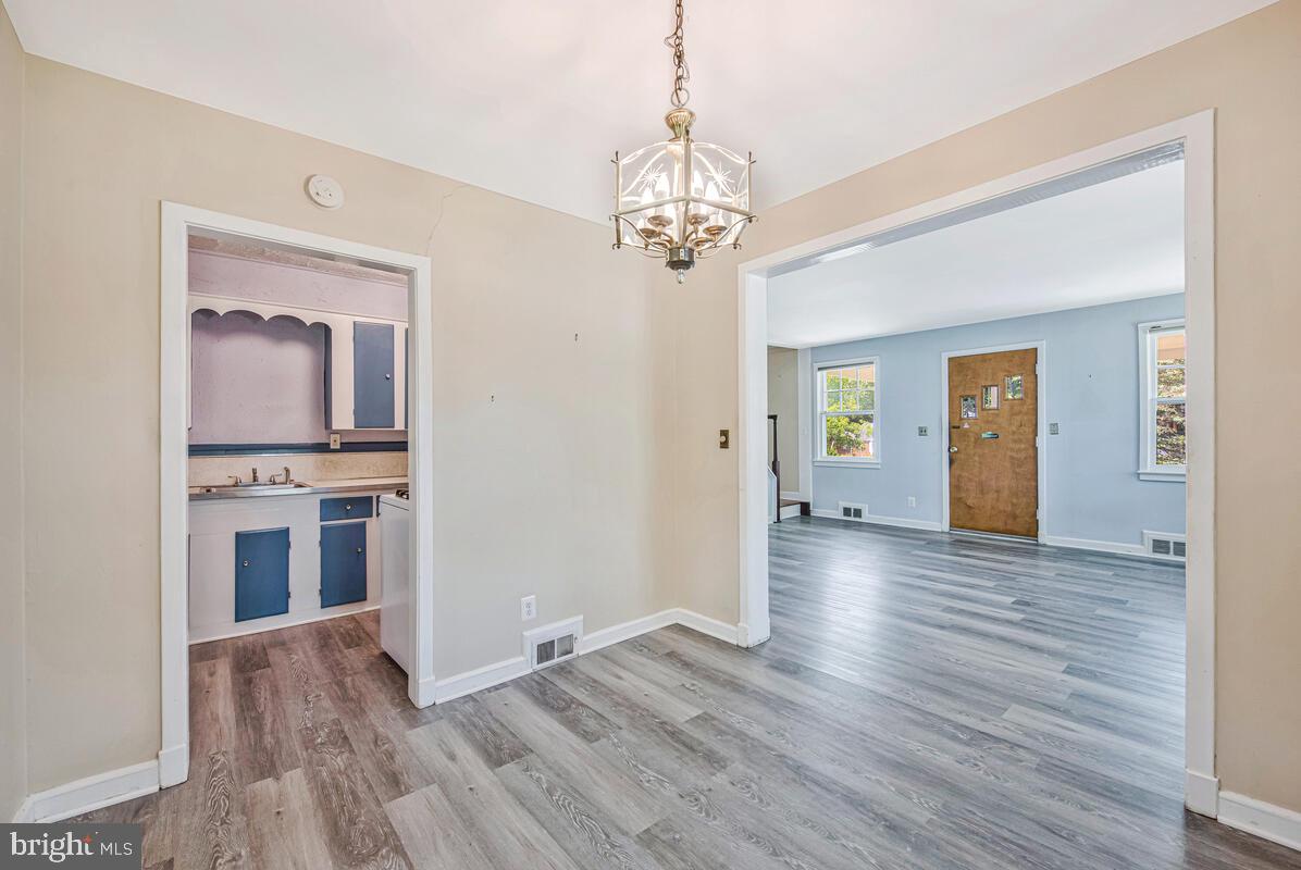 9425 Washington Boulevard Lanham, MD 20706 - Photo 11 of 38 a view of a hallway with wooden floor and a living room