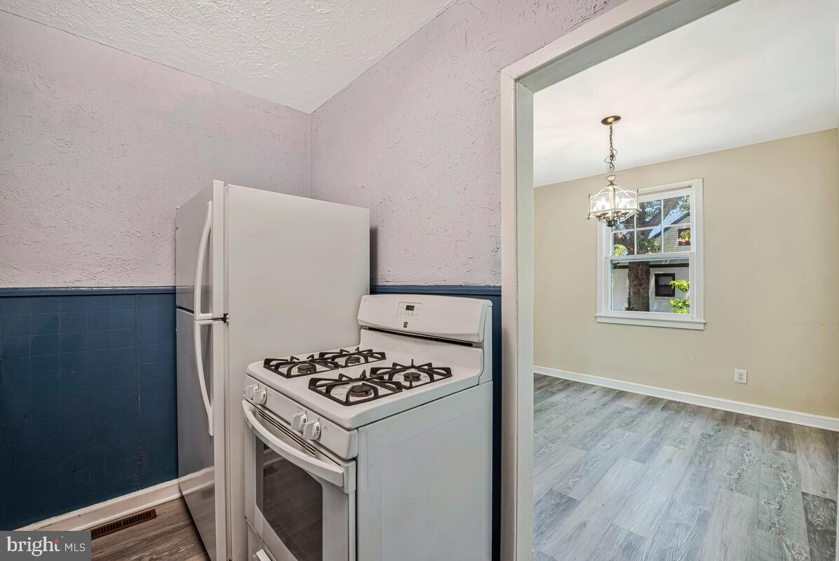 9425 Washington Boulevard Lanham, MD 20706 - Photo 14 of 38 a kitchen with a stove and a refrigerator