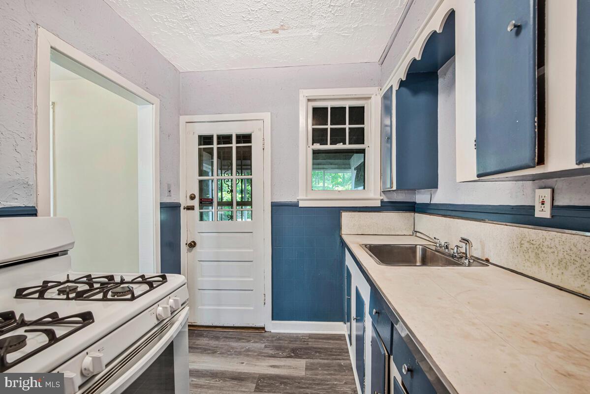 9425 Washington Boulevard Lanham, MD 20706 - Photo 15 of 38 a kitchen that has a sink and a stove