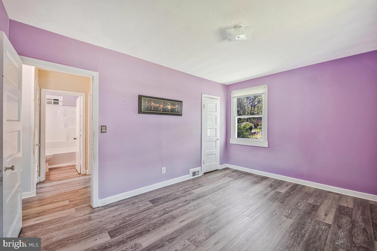 9425 Washington Boulevard Lanham, MD 20706 - Photo 19 of 38 an empty room with wooden floor and windows