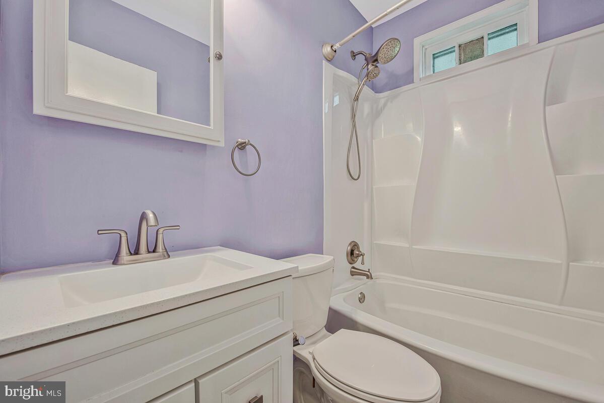 9425 Washington Boulevard Lanham, MD 20706 - Photo 20 of 38 a bathroom with a sink toilet and shower