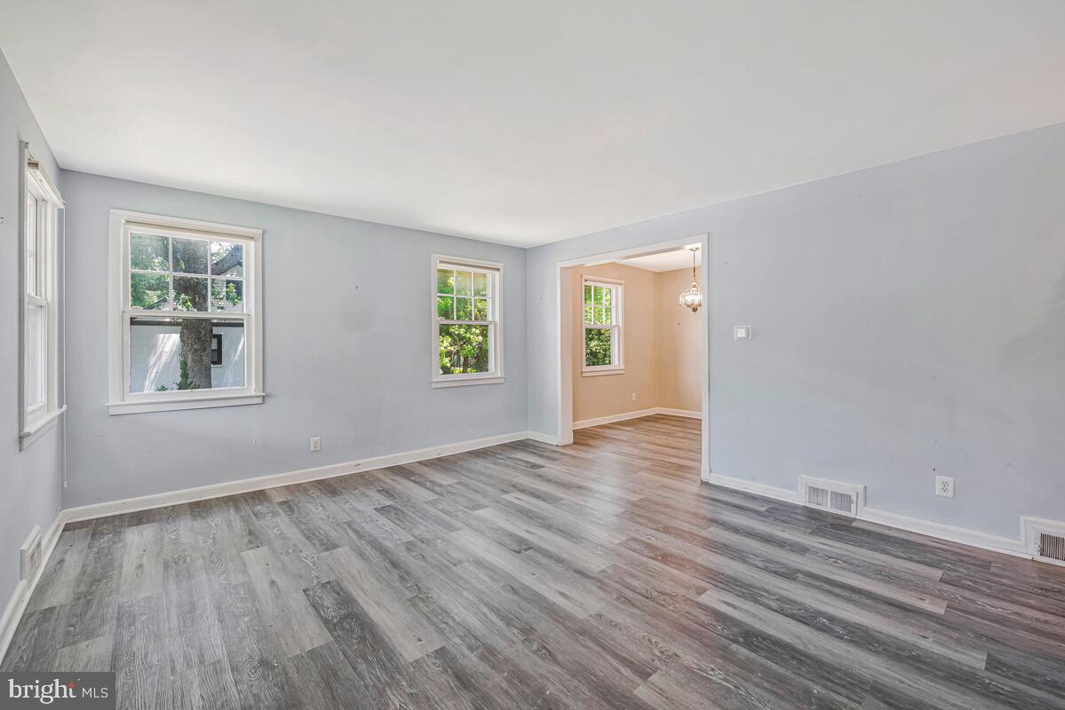 9425 Washington Boulevard Lanham, MD 20706 - Photo 5 of 38 an empty room with wooden floor and windows