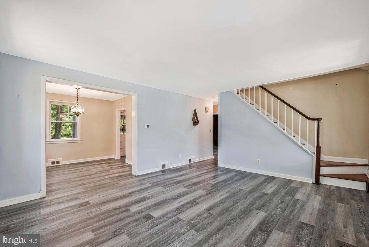 9425 Washington Boulevard Lanham, MD 20706 - Photo 6 of 38 a view of an empty room with wooden floor and a window