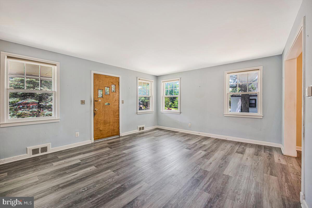 9425 Washington Boulevard Lanham, MD 20706 - Photo 8 of 38 a view of an empty room with window and wooden floor