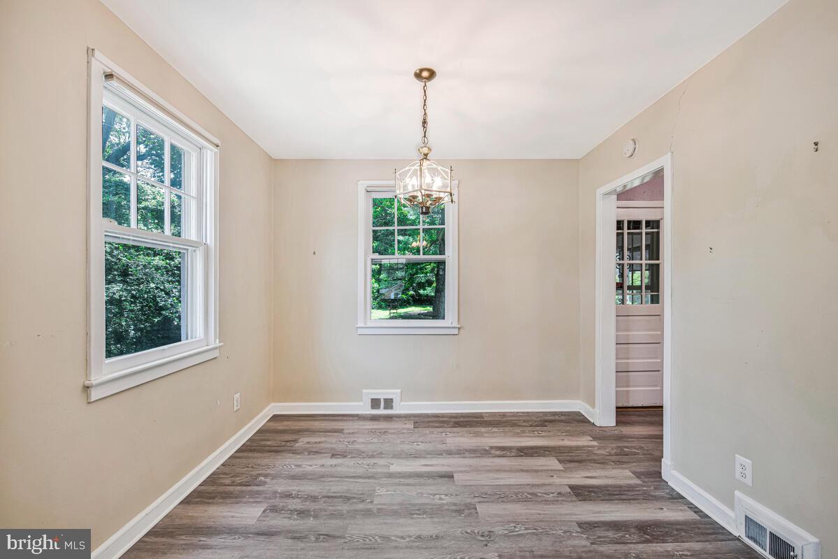 9425 Washington Boulevard Lanham, MD 20706 - Photo 9 of 38 a view of empty room with window and wooden floor