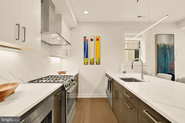 a kitchen with a sink a counter and cabinets