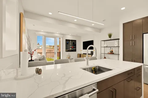 a kitchen with a sink and a refrigerator