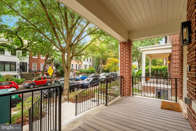a view of a porch with wooden floor and furniture