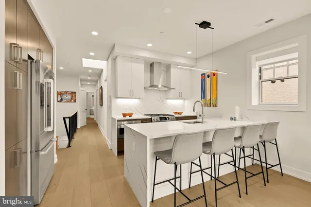 a kitchen with stainless steel appliances a sink stove and refrigerator