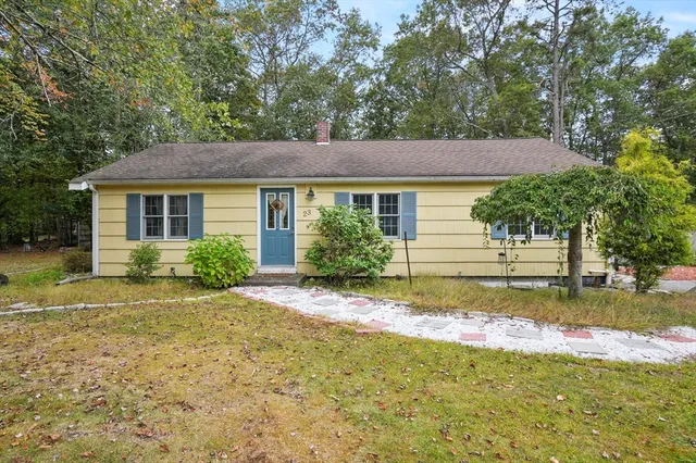 a view of backyard of house with green space