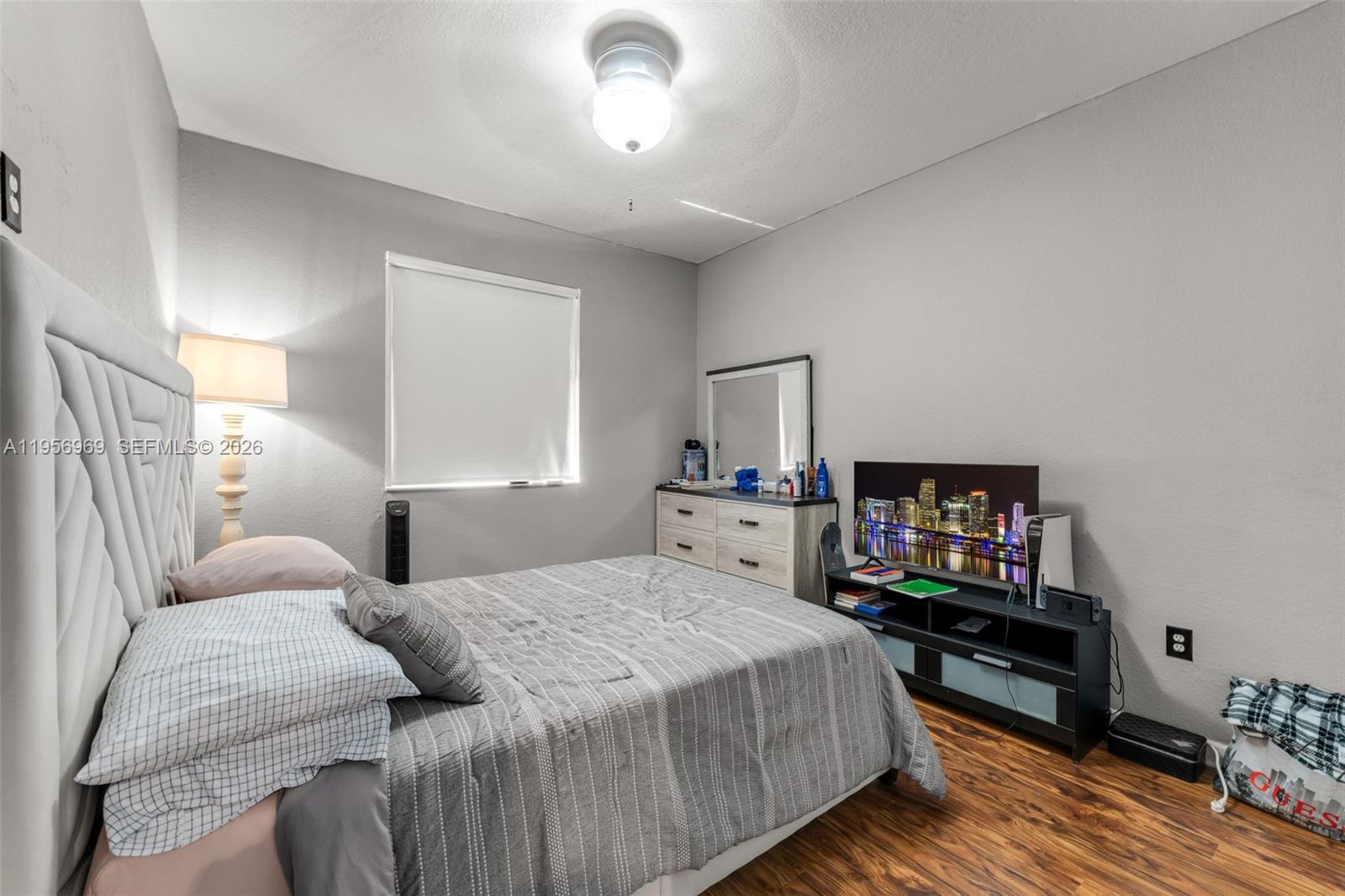 12965 Southwest 133rd Terrace Miami, FL 33186 - Photo 17 of 42 a bedroom with a bed and a tv on table