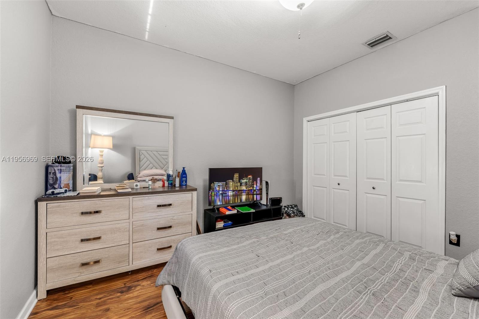 12965 Southwest 133rd Terrace Miami, FL 33186 - Photo 19 of 42 a bedroom with a bed and a dresser