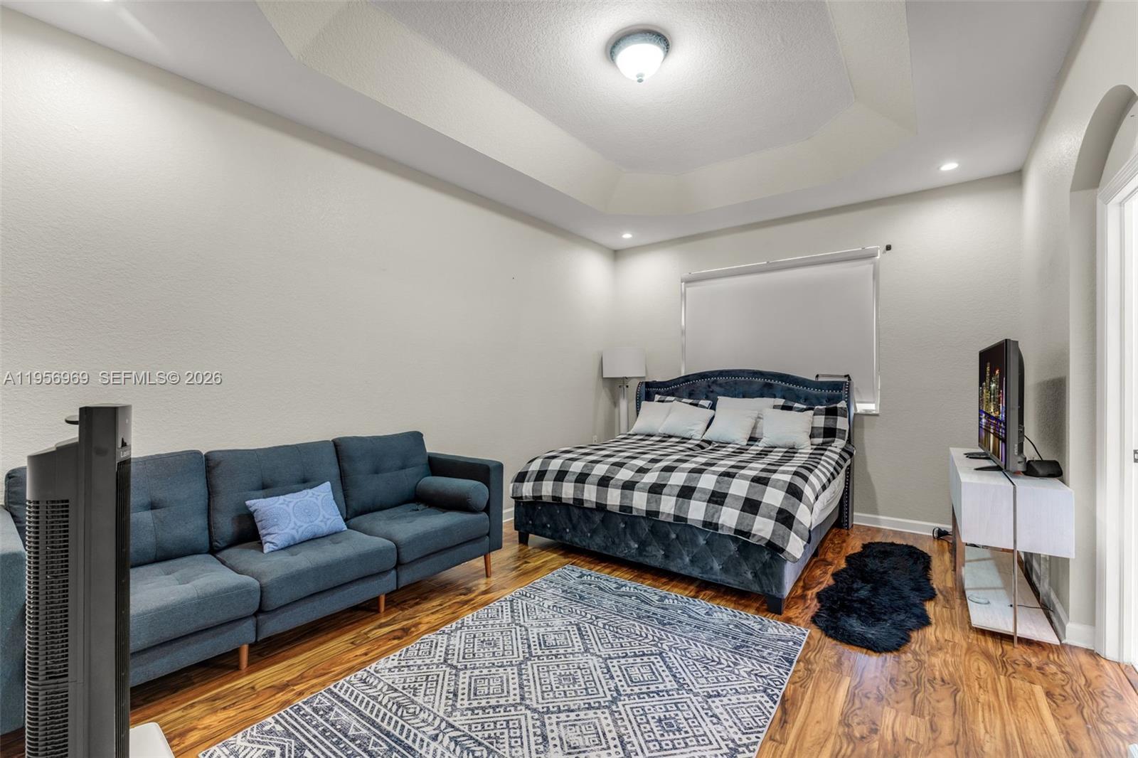 12965 Southwest 133rd Terrace Miami, FL 33186 - Photo 22 of 42 a bedroom with furniture and a wooden floor