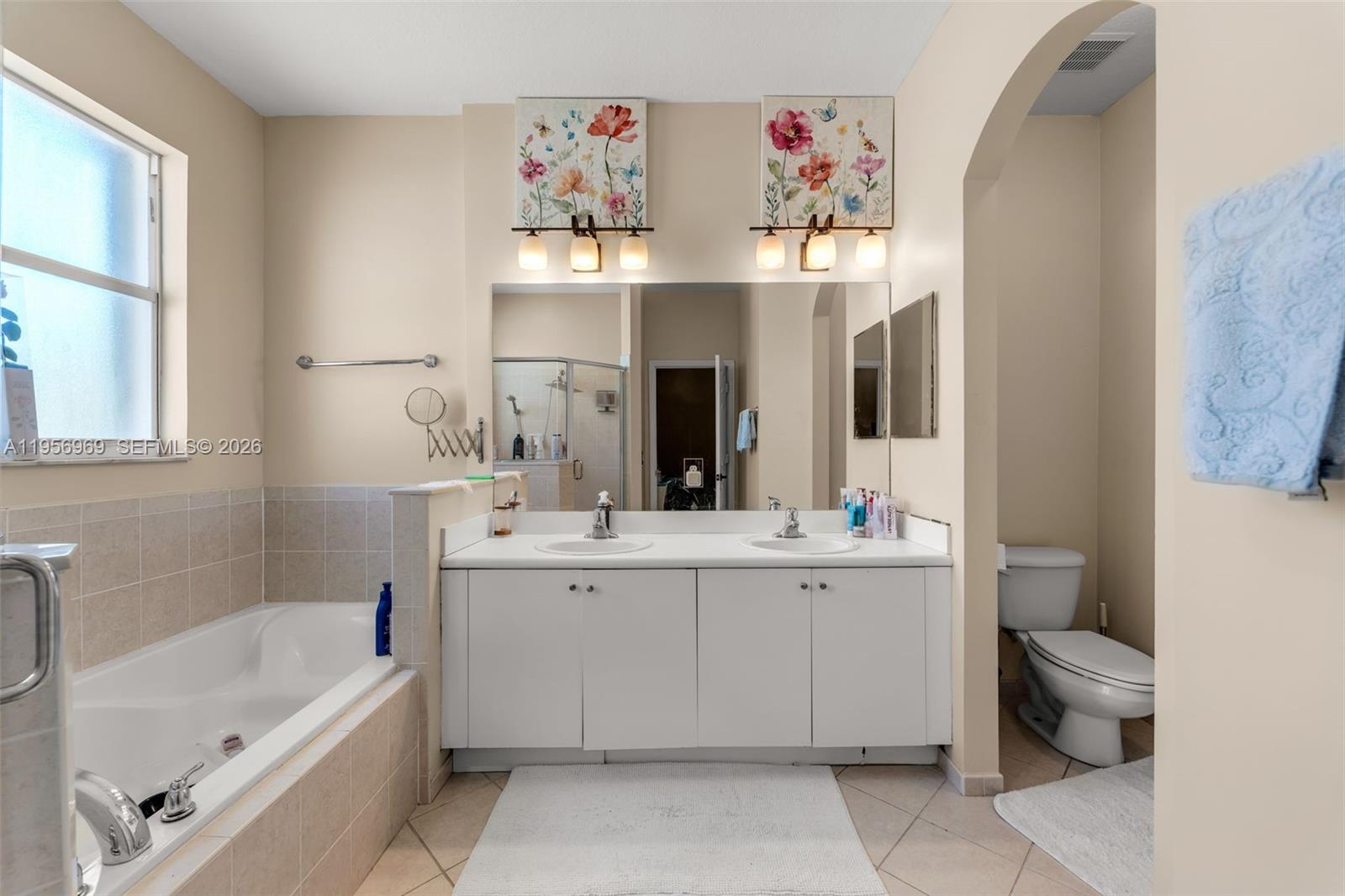 12965 Southwest 133rd Terrace Miami, FL 33186 - Photo 25 of 42 a bathroom with a bathtub sink and mirror