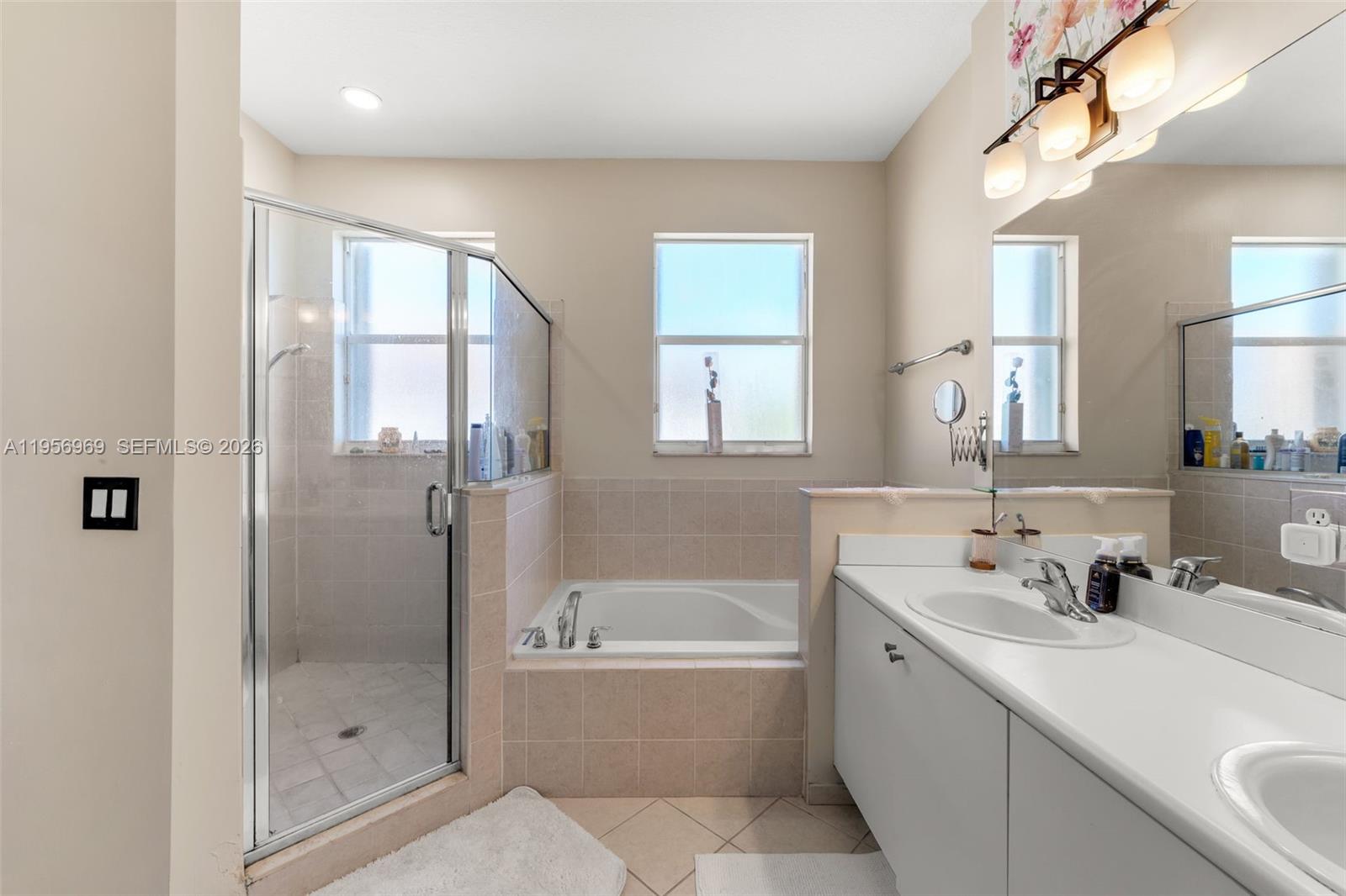 12965 Southwest 133rd Terrace Miami, FL 33186 - Photo 26 of 42 a bathroom with a tub sink and mirror