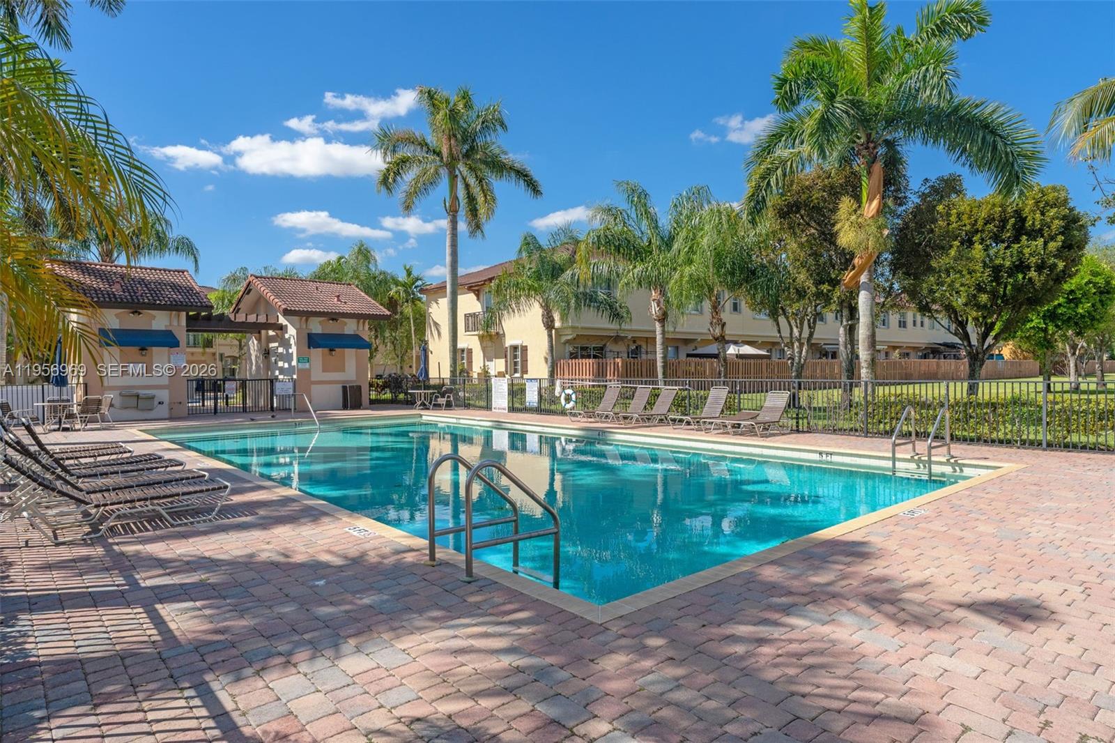 12965 Southwest 133rd Terrace Miami, FL 33186 - Photo 30 of 42 a view of a swimming pool with a patio