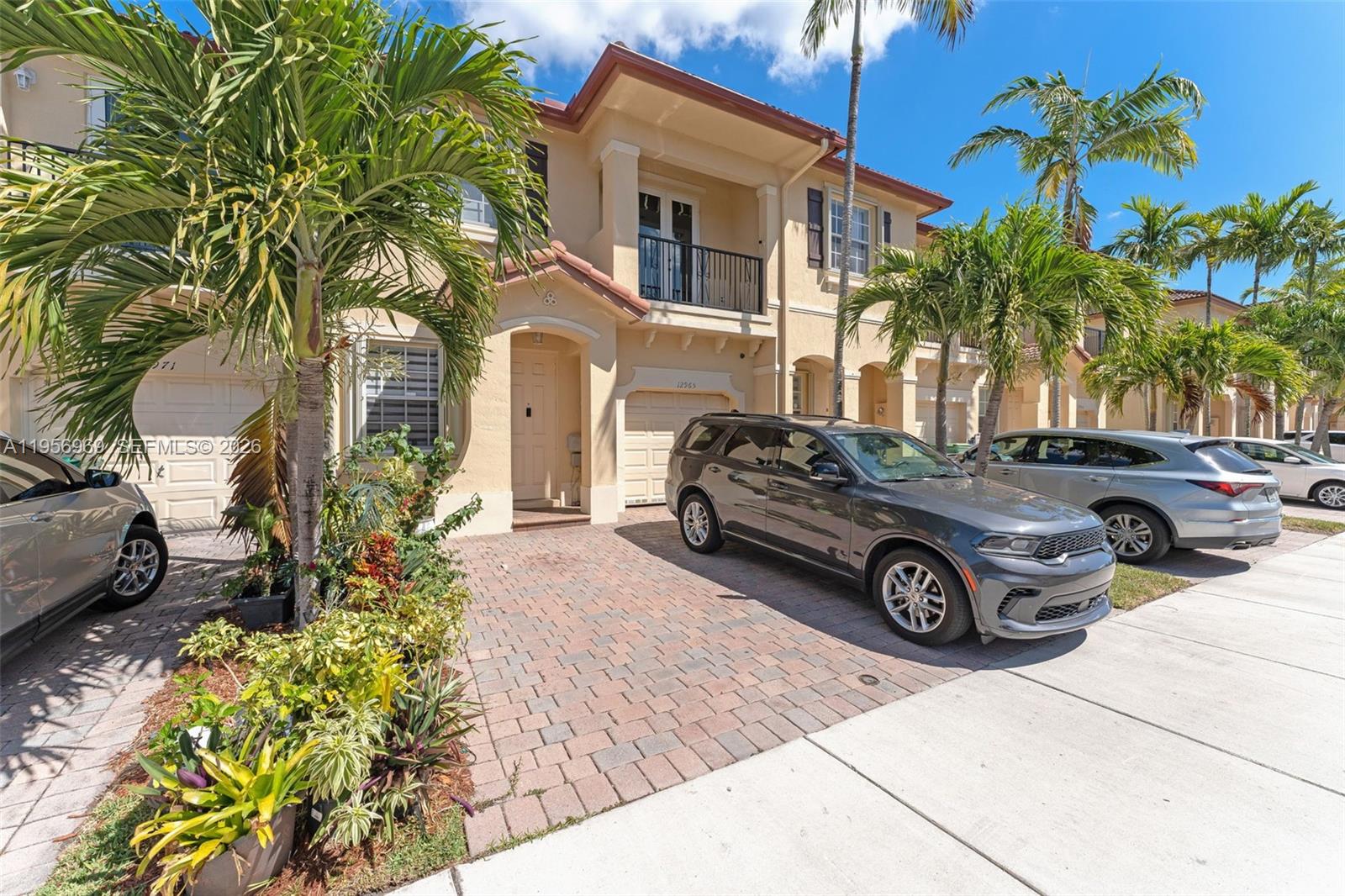 12965 Southwest 133rd Terrace Miami, FL 33186 - Photo 3 of 42 a view of a car parked in front of a house