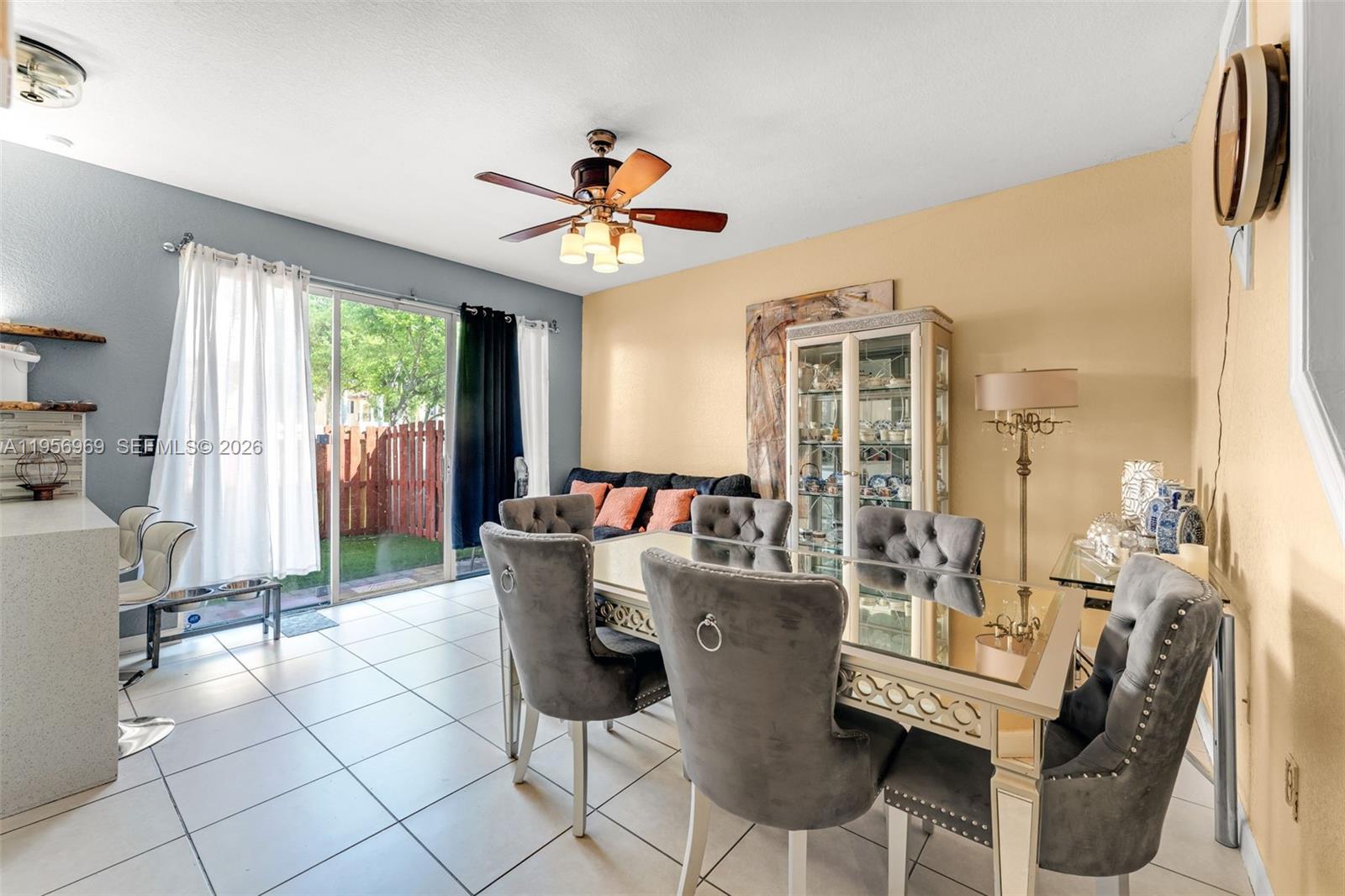 12965 Southwest 133rd Terrace Miami, FL 33186 - Photo 7 of 42 a living room with furniture a fireplace and a chandelier