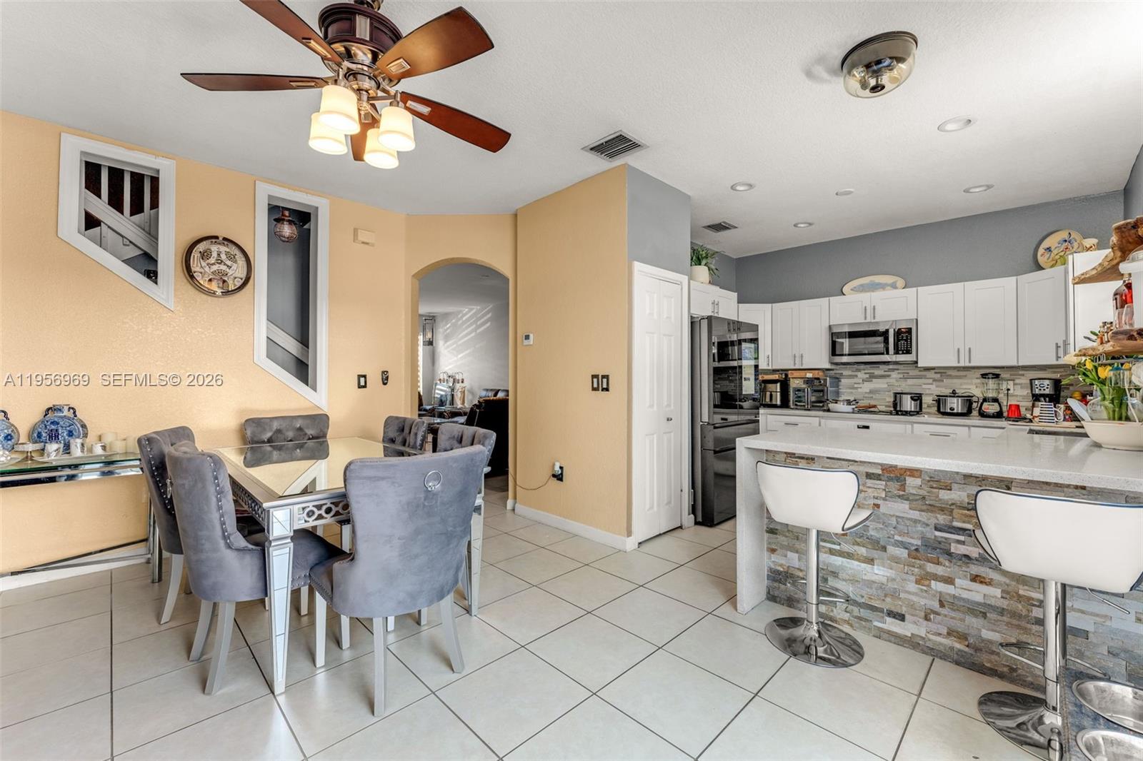 12965 Southwest 133rd Terrace Miami, FL 33186 - Photo 9 of 42 a dining room with furniture and kitchen view