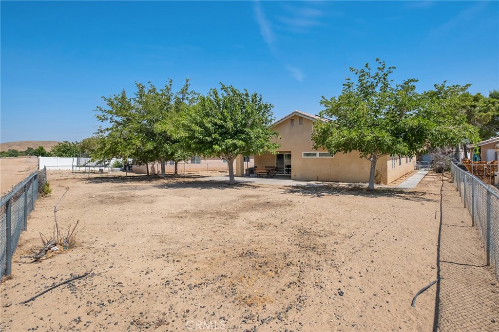 14952 Rivers Edge Road Helendale, CA 92342 - Photo 32 of 33 a view of a yard with a tree