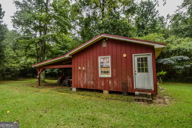 a view of backyard of house with green space