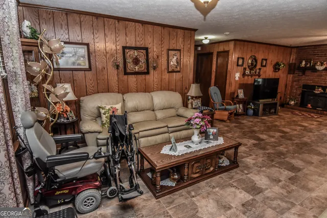 a living room with furniture a dining table and a projector screen