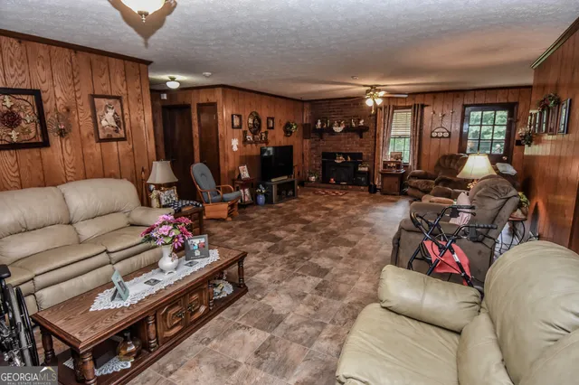 a living room with furniture a flat screen tv and a fireplace