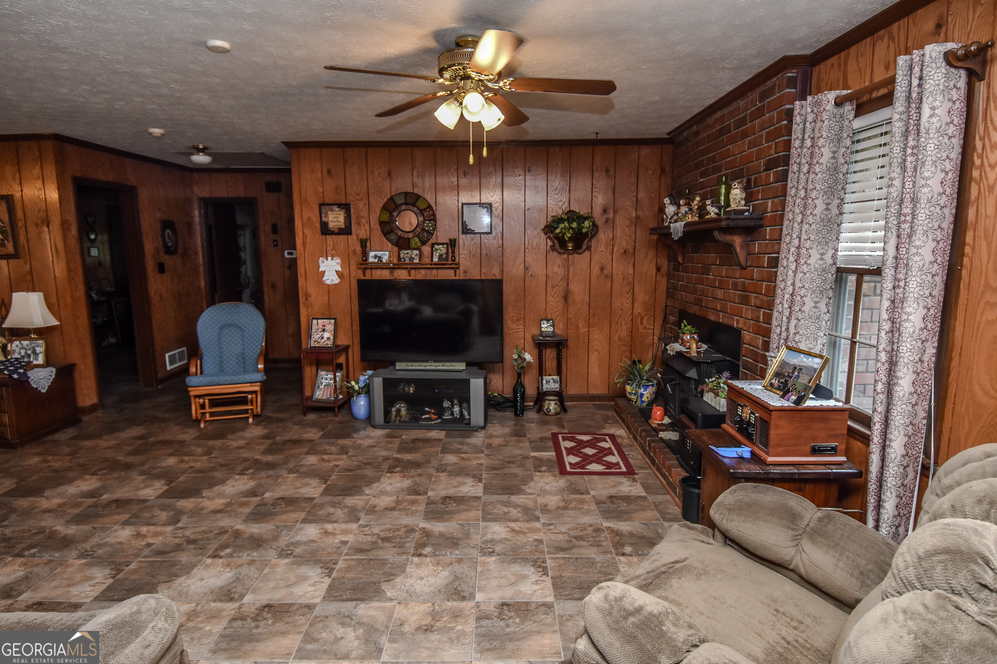 223 Ward Road Williamson, GA 30292 - Photo 45 of 51 a living room with furniture a flat screen tv and a fireplace