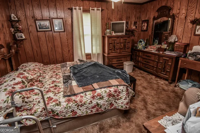 a bedroom with a bed and a television