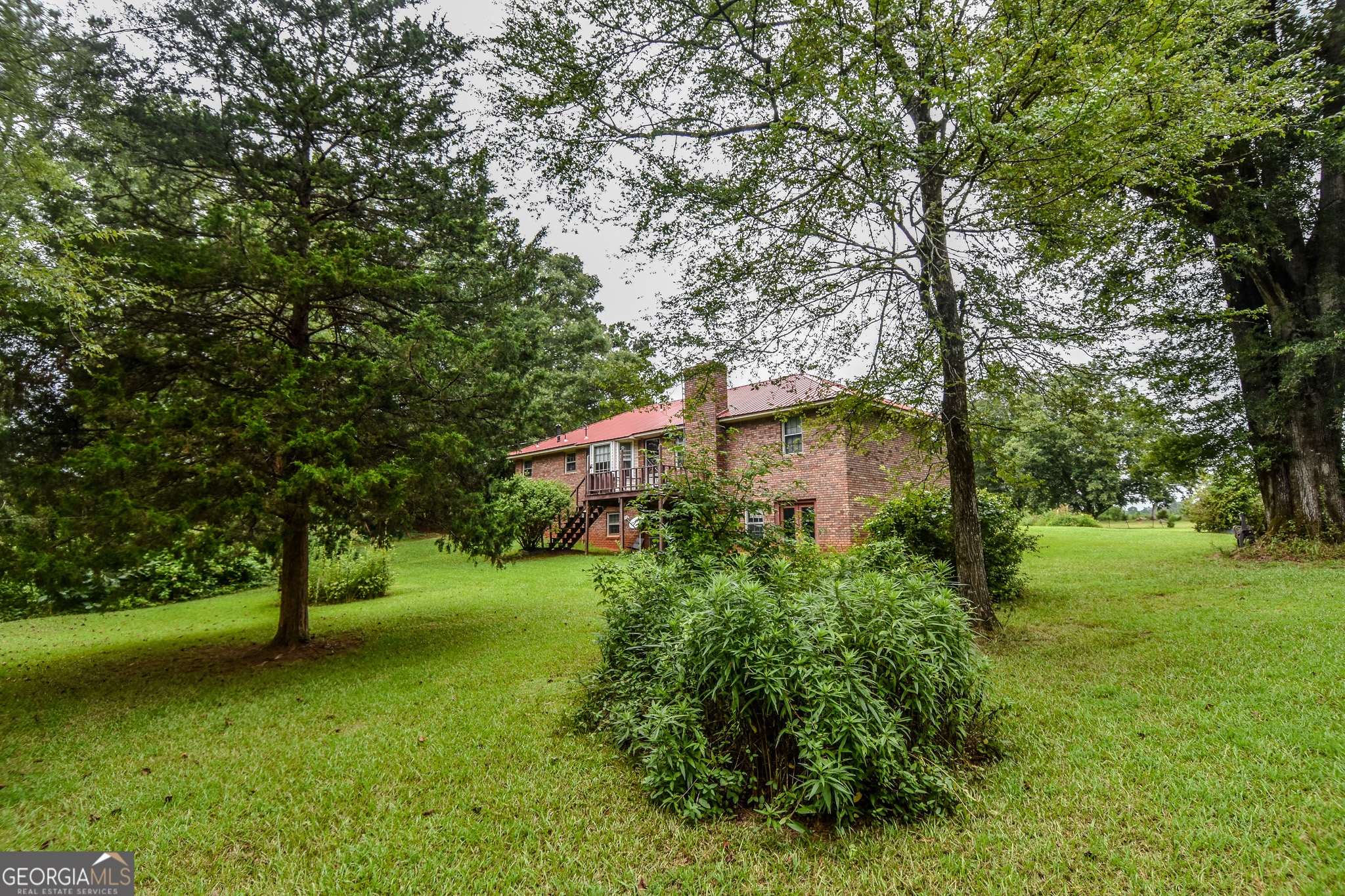223 Ward Road Williamson, GA 30292 - Photo 9 of 51 a view of a garden with large trees