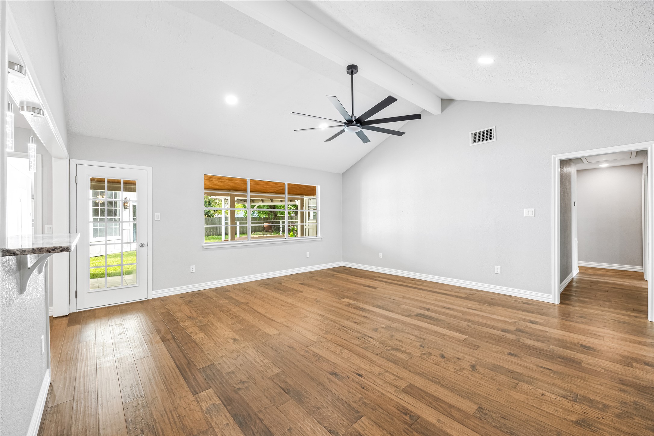 9806 Tanager Lane Conroe, TX 77385 - Photo 8 of 28 a view of an empty room with a window and wooden floor