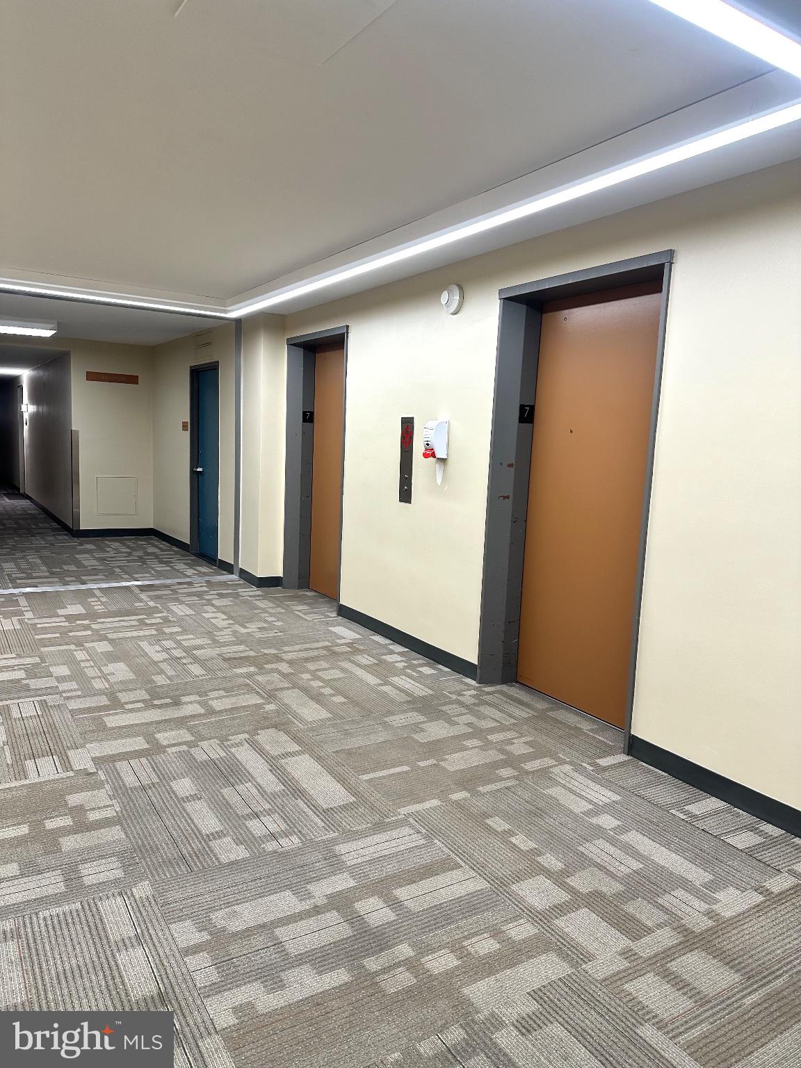 4600 Duke Street, Unit 701 Alexandria, VA 22304 - Photo 27 of 36 Modern corridor with inviting doors.