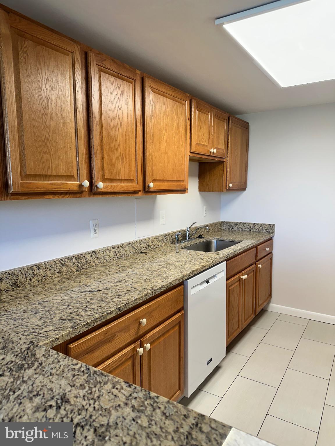 4600 Duke Street, Unit 701 Alexandria, VA 22304 - Photo 4 of 36 Modern kitchen with warm wood accents.