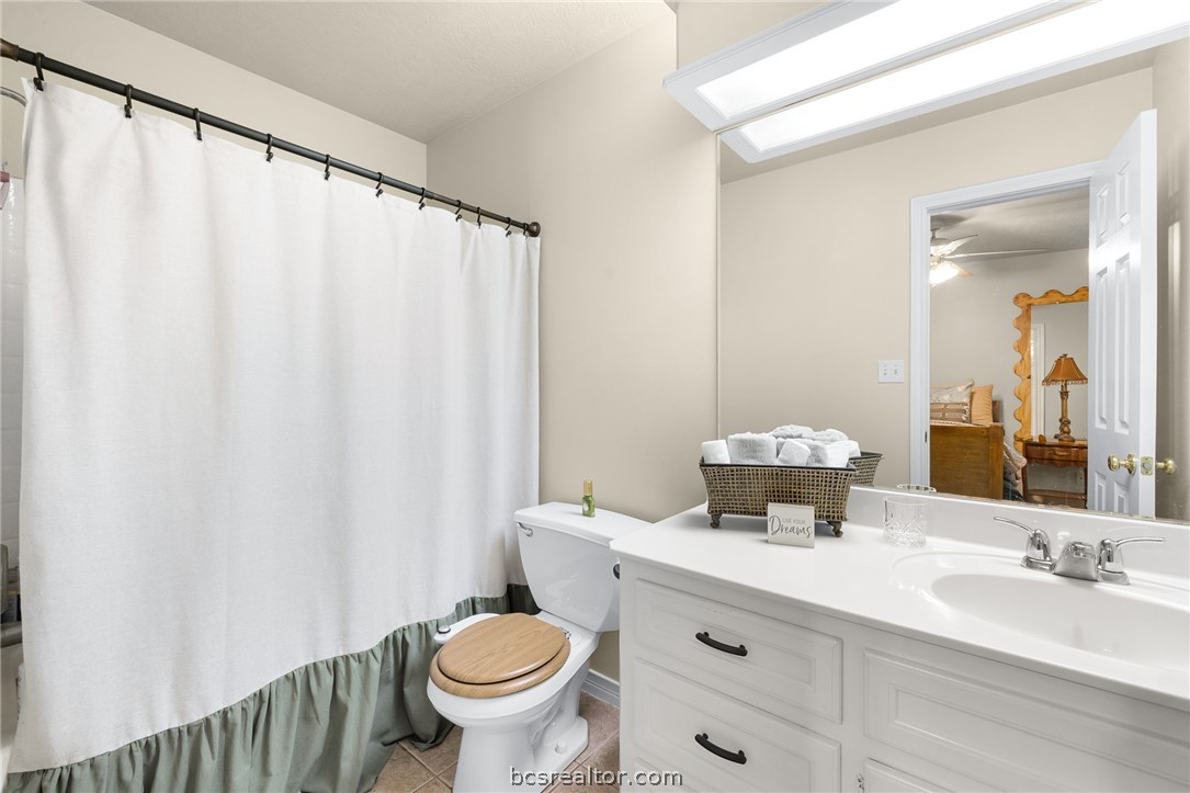 2287 North Earl Rudder Freeway Bryan, TX 77803 - Photo 4 of 32 a bathroom with a sink a toilet and a mirror