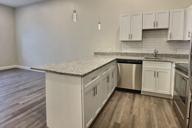 a kitchen with a sink stove and cabinets