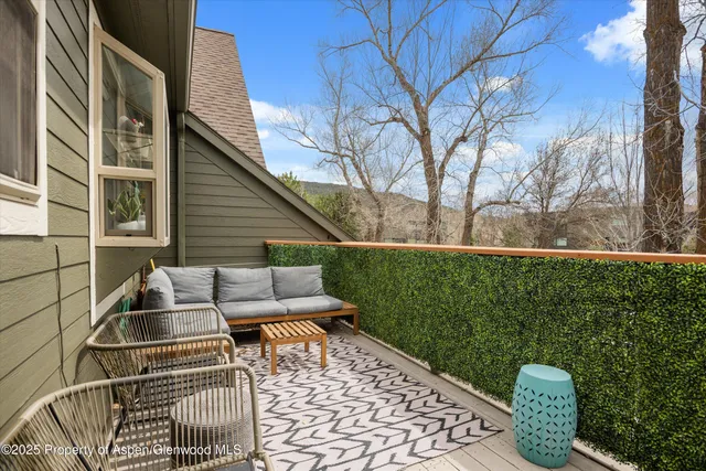 a view of backyard with outdoor seating and plants
