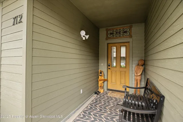 a view of a door and chair in the balcony