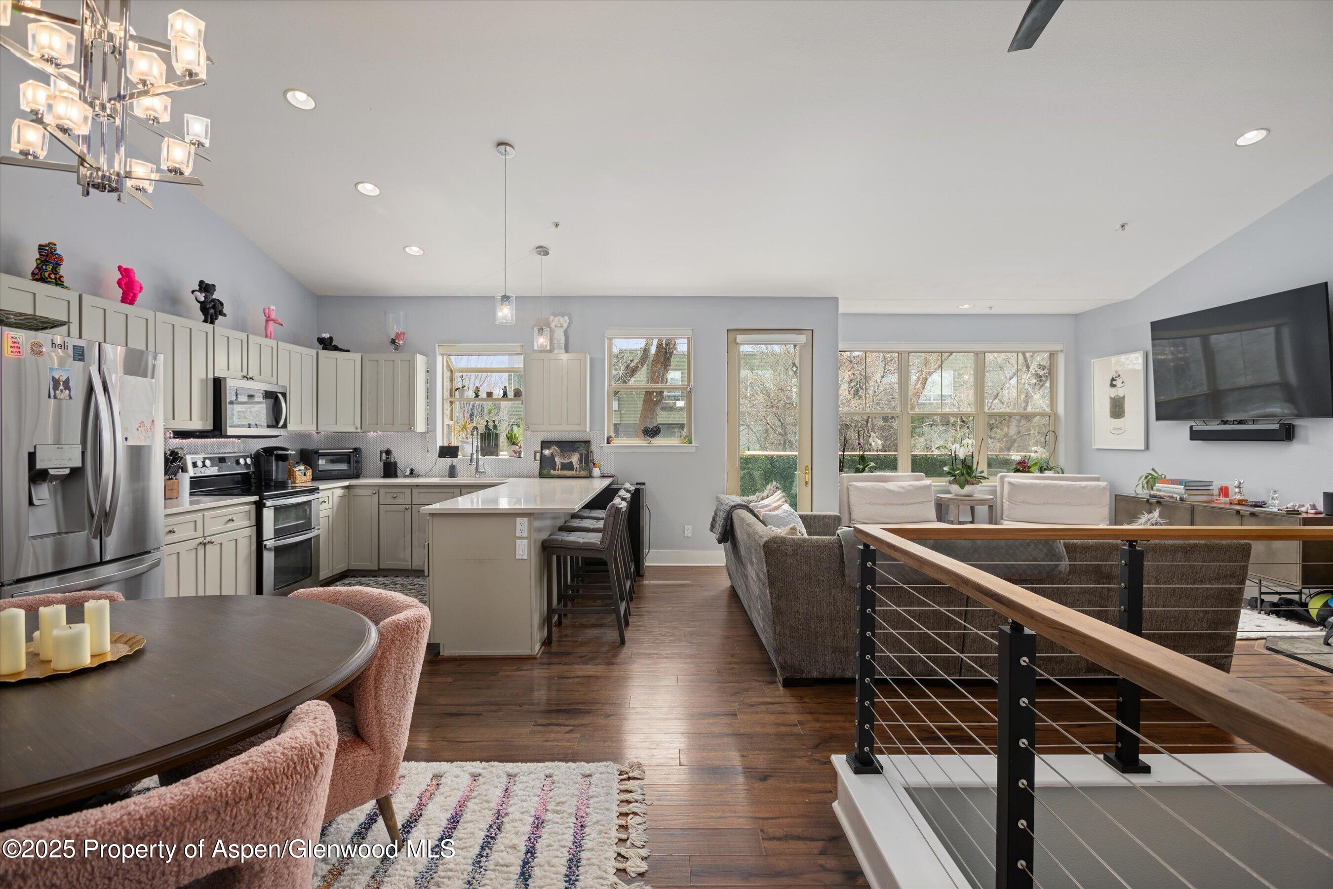 712 Evans Court Basalt, CO 81621 - Photo 8 of 23 a kitchen with counter space dining table and stainless steel appliances