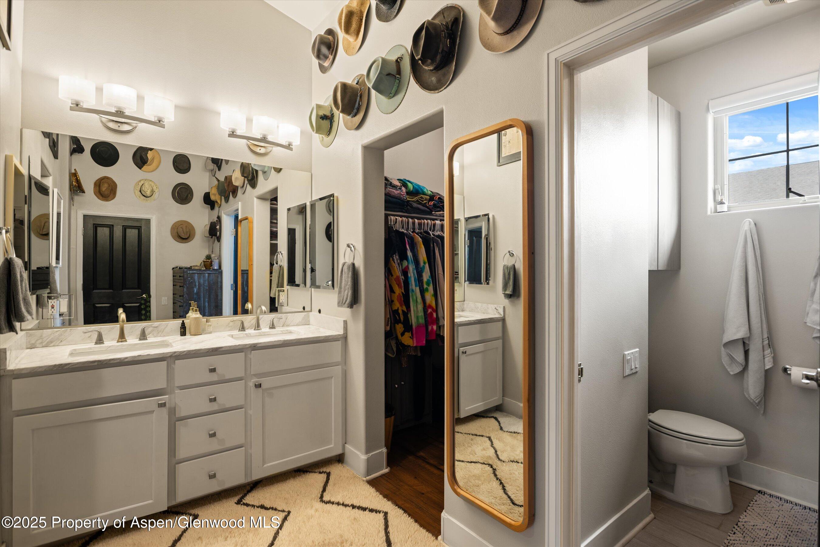 712 Evans Court Basalt, CO 81621 - Photo 10 of 23 a bathroom with a double vanity sink toilet and shower