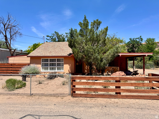 178 Walnut Lane Moab, UT 84532 - Photo 24 of 25 Exterior facade featuring a pitched roof, multiple windows, and a covered porch