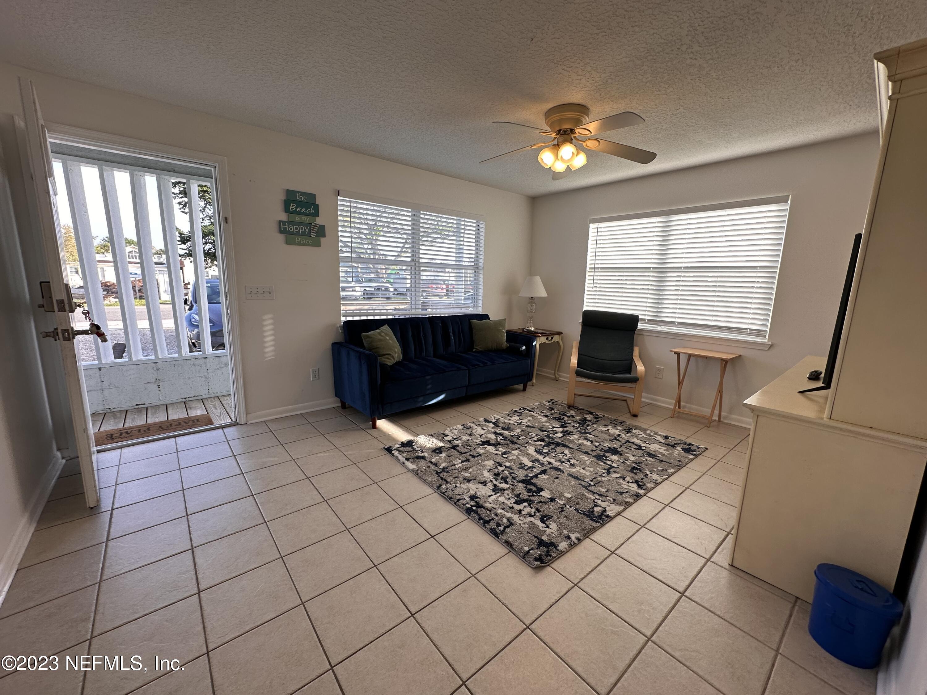 422 4th Avenue North Jacksonville Beach, FL 32250 - Photo 1 of 15 a living room with hard wood floor furniture a rug and a window